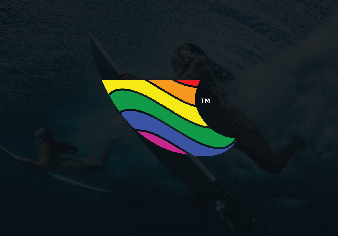 Paddle Out surf brand logo featuring a shark fin shape with vibrant rainbow stripes, overlaid on a dark ocean background.