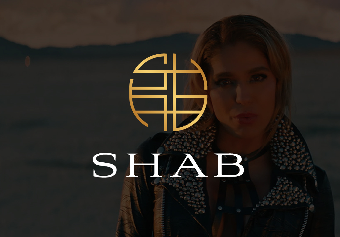 Golden SHAB logo, stylized with interconnected lines, overlaid on a dark, dramatic portrait of Persian singer Shabnam (SHAB).